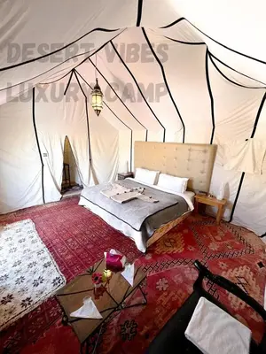 a bedroom with a bed in a tent at Desert vibes Luxury camp in Merzouga