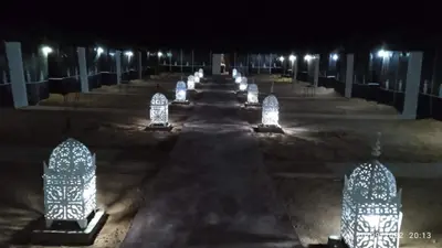 a row of lights in a parking lot at night at Merzougadreamcamp in Merzouga