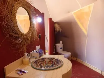 a bathroom with a sink and a mirror at Merzougadreamcamp in Merzouga