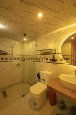 a bathroom with a toilet and a sink at Serenity apartments in Azrou