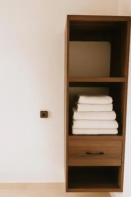 a wooden shelf with folded towels in a room at Serenity apartments in Azrou