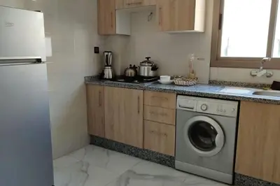 a kitchen with a washing machine and a sink at Luxe & Air Conditionner & Calme appartement in Fès