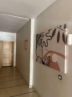 a hallway with a painting on the wall at Luxe & Air Conditionner & Calme appartement in Fès