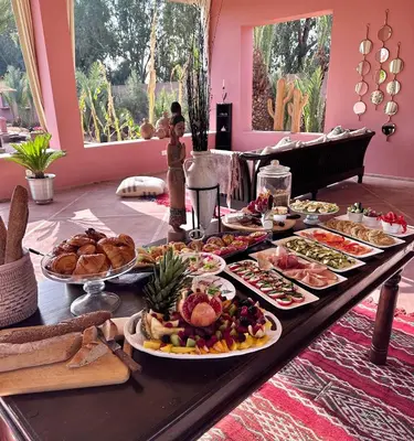 a table with many plates of food on it at Maison Amâra Marrakech in Marrakech