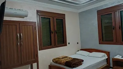 a small bedroom with a bed and some cabinets at IAZAL Hotel Ouarzazate in Ouarzazate
