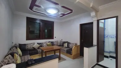 a living room with a couch and a table at IAZAL Hotel Ouarzazate in Ouarzazate