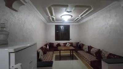 a living room with a couch and a table at IAZAL Hotel Ouarzazate in Ouarzazate