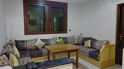 a living room with a couch and a table at IAZAL Hotel Ouarzazate in Ouarzazate