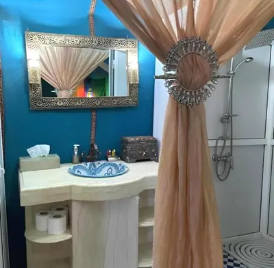 a bathroom with a sink and a mirror at Majestic Dunes Luxury Camp in Merzouga