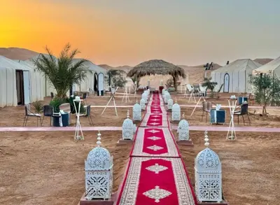 a red and white altar in the desert with tents at Majestic Dunes Luxury Camp in Merzouga