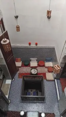 an overhead view of a bathroom with a clock on the floor at Narjis House in Fès