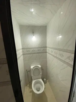 a bathroom with a white toilet in a room at Appartement Calme (1) in Fès