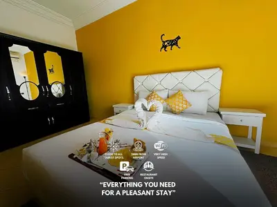 a poster of a bedroom with a bed with yellow walls at CHAY - Appartements a Ouarzazate in Ouarzazate