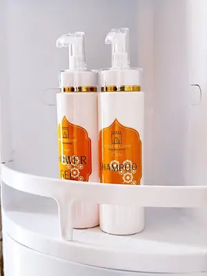 two bottles of sunscreen sitting on a shelf in a refrigerator at CHAY - Appartements a Ouarzazate in Ouarzazate