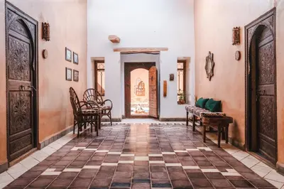 a hallway with chairs and a table in a building at Kasbah Tiziri in Kalaat MGouna