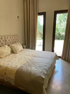 a bedroom with a large bed and a large window at Sliwa house la Perle de la ville Ocre in Marrakech