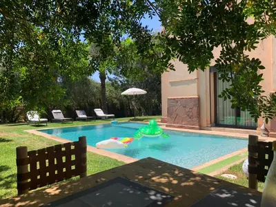 a swimming pool with a green toy in it at Sliwa house la Perle de la ville Ocre in Marrakech