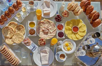a table filled with different types of breakfast foods at Sliwa house la Perle de la ville Ocre in Marrakech