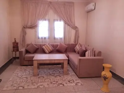 a living room with a couch and a table at Résidence Ayour in Ouarzazate