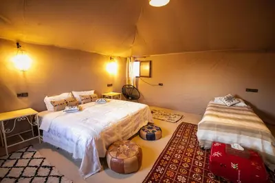 a bedroom with two beds in a tent at beduincamp in Hassilabied