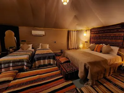 a bedroom with two beds in a tent at beduincamp in Hassilabied