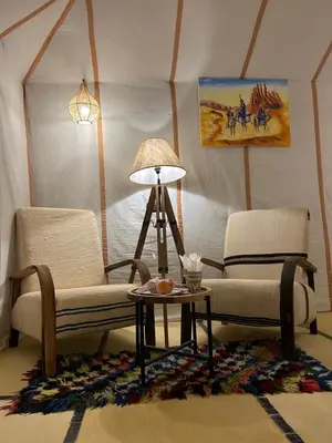 a living room with two chairs and a table at Luxury Nomad Style in Merzouga