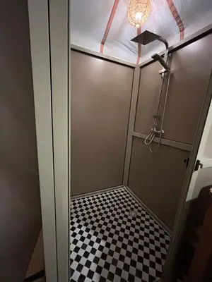 a shower stall with a black and white checkered floor at Luxury Nomad Style in Merzouga