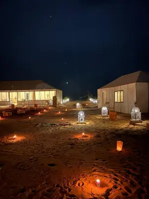 a group of buildings with lights at night at Luxury Nomad Style in Merzouga