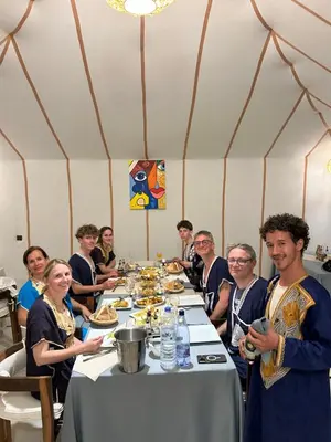 a group of people sitting around a table in a tent at Luxury Nomad Style in Merzouga