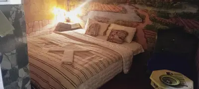a bed with a cross on top of it at Dar Mayssa Rose in Zawyat