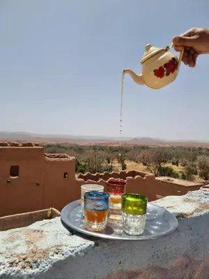 a tray with three glasses on top of a building at Dar Mayssa Rose in Zawyat