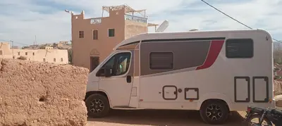 a white van parked in front of a building at Dar Mayssa Rose in Zawyat