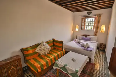 a living room with a couch and a bed at Dar Authentic Fes - familly hosting in Fès