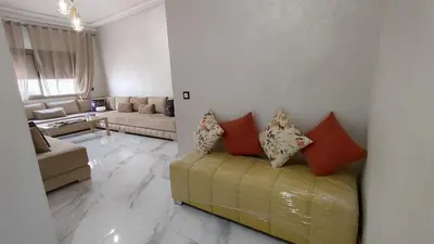 a living room with a couch with pillows on it at coin famille in Fès