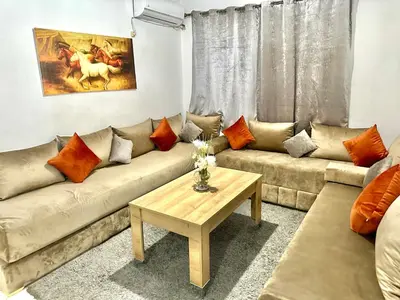 a living room with a couch and a table at A modern apartment in Fès