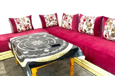 a red couch with a table on top of it at A modern apartment in Fès