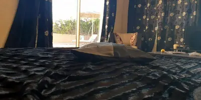 a bed with a pillow on it with a window at Maison d'Hôtes à Marrakech in Marrakech