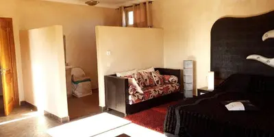 a room with a bed and a couch in it at Maison d'Hôtes à Marrakech in Marrakech