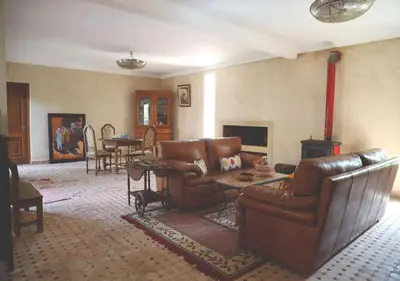 a living room with leather furniture and a fireplace at Maison d'Hôtes à Marrakech in Marrakech