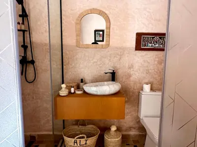 a bathroom with a sink and a toilet and a mirror at Alibaba Riad in Fès
