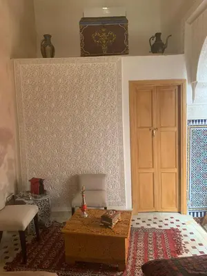 a room with a door and a table in a room at Alibaba Riad in Fès