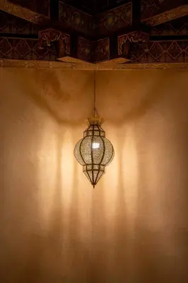a chandelier hanging from a wall in a room at Alibaba Riad in Fès
