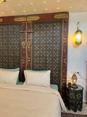 a bedroom with a large bed and a wall at Alibaba Riad in Fès