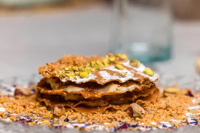 a stack of cookies with nuts on top of it at Riad Villa Amood in Merzouga