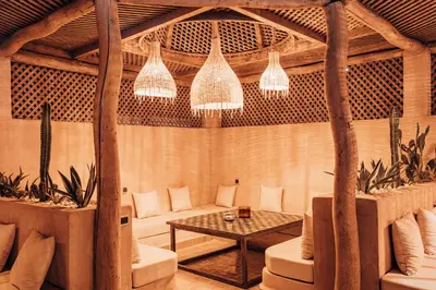 a living room with a couch and a table at Riad Villa Amood in Merzouga