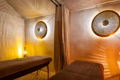 a room with a bed and two mirrors on the wall at Dar Syada Boutique Hotel & SPA Marrakech in Marrakech