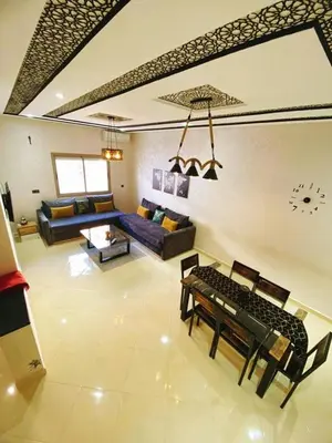 a living room with a couch and a table at Appartement calme top in Fès