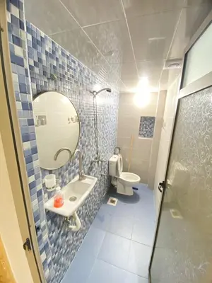 a bathroom with a sink and a mirror and a toilet at Appartement calme top in Fès