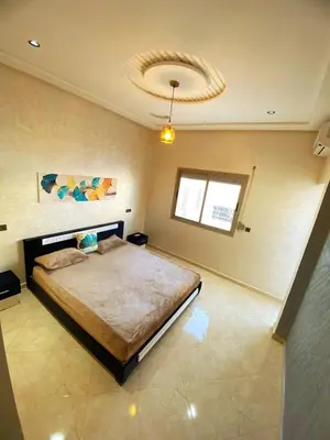a bedroom with a large bed in a room at Appartement calme top in Fès