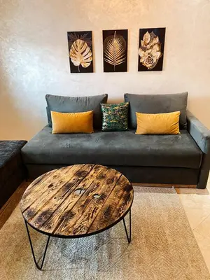 a living room with a couch and a coffee table at Appartement calme top in Fès